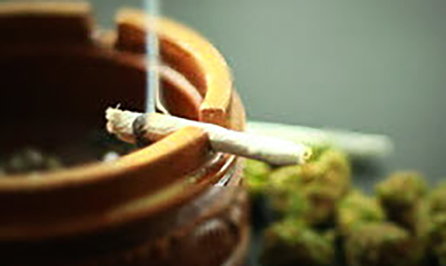burning marijuana cigarette on ashtray