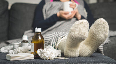 Woman with the flu taking medicine